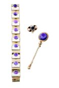 An amethyst bracelet, set along the length with 9 oval cabochon amethysts in rectangular polished