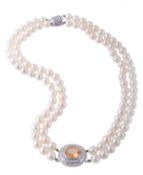 A two strand cultured pearl necklace, the one hundred 6.9mm cultured pearls centred with an oval