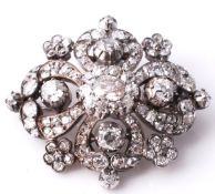 A late Victorian diamond cluster brooch, circa 1880, the central oval shaped old cut diamond within