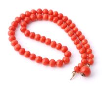 A coral bead necklace, the sixty three graduated polished coral beads (corallium rubrum) measuring