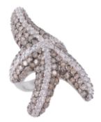 A diamond starfish dress ring, the naturalistic starfish pave set with diamonds and brown tinted