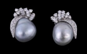 A pair baroque cultured pearl and diamond earrings, the silver toned cultured pearls with shaped