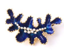 An enamel and diamond marine plant brooch, of lobed form with blue enamelling and a central cluster