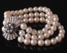 A cultured pearl bracelet with a sapphire and diamond clasp, the three rows of twenty one cultured