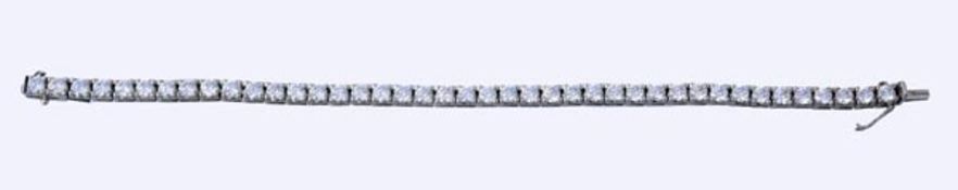 A diamond line bracelet, the brilliant cut diamonds in four claw settings to a concealled box