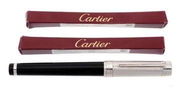 Must de Cartier, a Pasha rollerball pen with black composite body and Clou de Paris highlights to