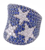 A sapphire and diamond dress ring, the broad concave band pave set with round cut sapphires with