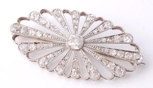 An Edwardian diamond brooch, circa 1915, the oval shape plaque millegrain collet set with an old
