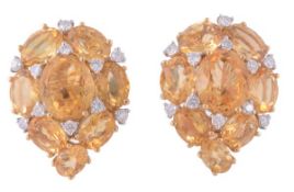 A pair of citrine and diamond ear clips, the pear shaped panels set throughout with oval shaped