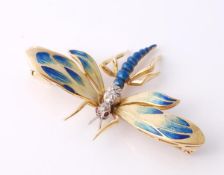 An enamel and diamond dragonfly brooch, with polychrome enamel to the wings, highlighted with eight