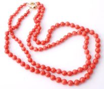 Two graduated coral bead necklaces, the first with beads measuring 6mm to 9mm, to an oval bead