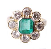 An emerald and diamond ring, the central collet set square shaped emerald within a surround of