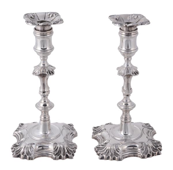 A matched pair of George II cast silver candlesticks by John Cafe, London 1749 and 1750, shaped