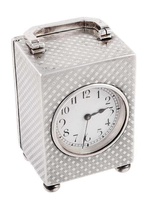 An Edwardian silver miniature travel clock, the case by William Comyns & Sons, London 1908, the