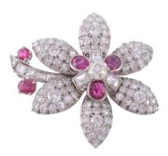 A ruby and diamond flower brooch, the flower head set with a central old cut diamond within a