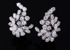 A pair of diamond set abstract cluster ear clips by Bucherer, the open work brilliant and marquise