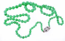 A graduated green jadeite bead necklace, the one hundred and thirteen graduated beads measuring 3.