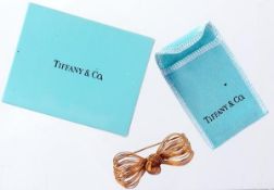 A bow brooch by Tiffany & Co., designed as a knotted bow composed of multi strands, signed