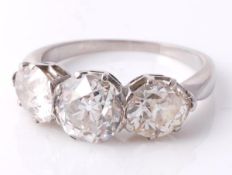 A diamond three stone ring, the central old brilliant cut diamond, weighing 1.52 carats, in a claw
