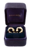 A pair of gold bamboo earrings by Tiffany & Co., the hoops with post fittings, signed T & Co.,