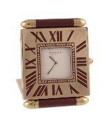 Cartier, a travel alarm clock, no. 35512240, the polished brass case with a folding front cover and