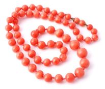 A coral bead necklace, the sixty graduated polished coral beads (corallium rubrum) measuring 7.7mm