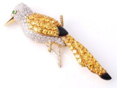 A gem set bird brooch, standing on a diamond accented branch, with a diamond pave set body,