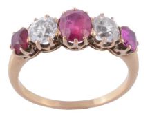 A ruby and diamond five stone ring, the central oval shaped ruby in a claw setting, between two