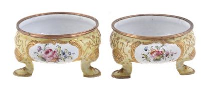 A pair of south Staffordshire enamel cauldron shape salt cellars, circa 1765-1770, painted with