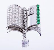 An emerald and diamond open book brooch, the brooch with a pave set diamond page, approximately 5.