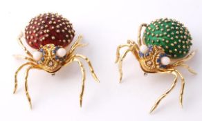 A pair of enamel spider brooches, the first with a red enamel body, the eyes set with circualr