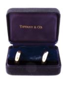 A pair of 18 carat gold earrings by Tiffany & Co., the higned hollow hoops with post fittings,