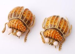 A pair of enamel beetle brooches, with polychrome enamel to wings and body, the eyes set with