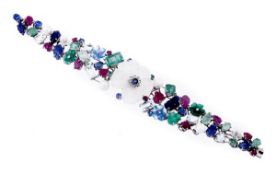 A multi gem floral bracelet, with a central rock crystal flower head with a sapphire and diamond