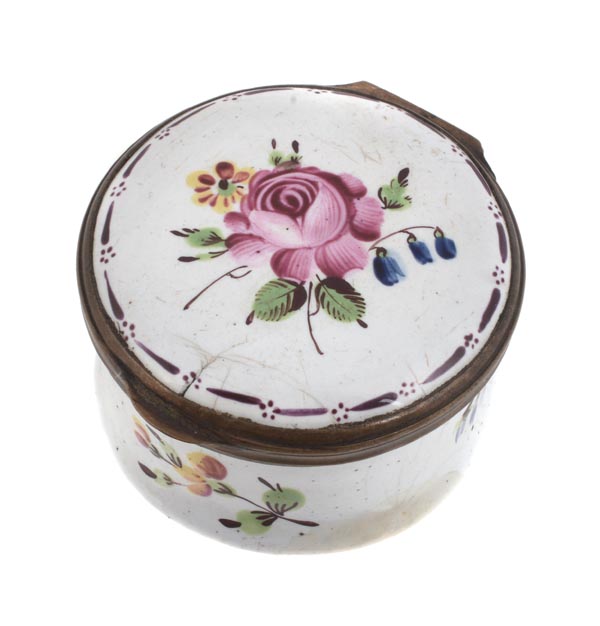A Bilston enamel circular snuff box, circa 1770-75, the cover painted with a flower sprig, within a