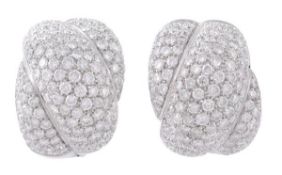 A pair of diamond ear clips, the cross over design pave set throughout with brilliant cut diamonds,
