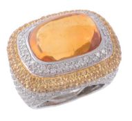 A citrine and diamond ring, the central rectangular cabochon citrine collet set within a surround