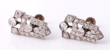 A pair of Art Deco diamond earrings, the pierced chevron panels millegrain set with three