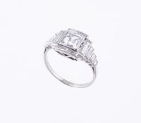 An Art Deco diamond ring, circa 1930, the central collet set square shaped diamond, weighing 1.50
