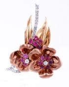 A 1940s ruby and diamond flower brooch, the polished gold coloured petals centred with a ruby and