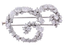 A diamond initial brooch by Van Cleef & Arples, the letter `E` set throughout with pear shaped,