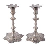 A matched pair of George II cast silver candlesticks, by William Gould, London 1750, and by John