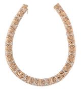 A diamond collar necklace, composed of alternating polished links and brilliant cut diamond set