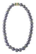 A hematite bead necklace, the thirty four uniform 12mm polished hematite beads with channel set