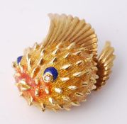 An enamel puffer fish brooch, with yellow, orange and blue enamel, the eyes set with eight cut