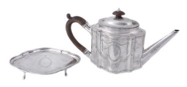 A George III silver commode shape straight-sided tea pot and an associated stand, the tea pot by