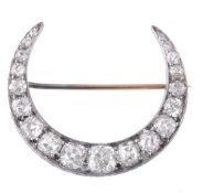 A Victorian diamond crescent brooch, circa 1890, the crescent set throughout with old cut diamonds,