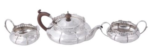 A silver compressed spherical three piece tea service by Walker & Hall, Birmingham 1924 and 1925,