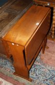 An Arts and Crafts oak drop leaf table on shaped supports 82cm extended, attributed to Arthur