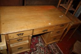 A late 19th century pine pedestal desk with seven drawers 81cm high, 137cm wide